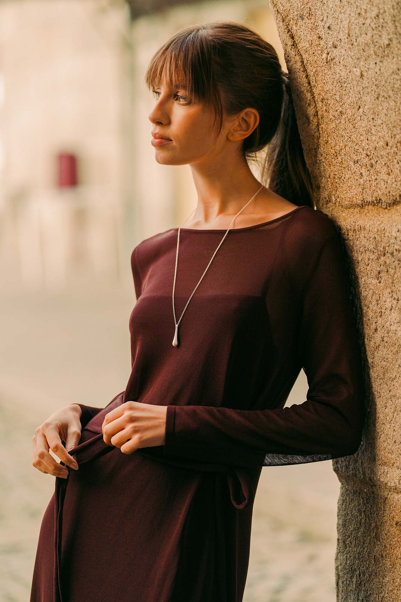 A fine Reflections pendant necklace worn over a wine-coloured knit, jewellery gift guide by Sofia Godinho