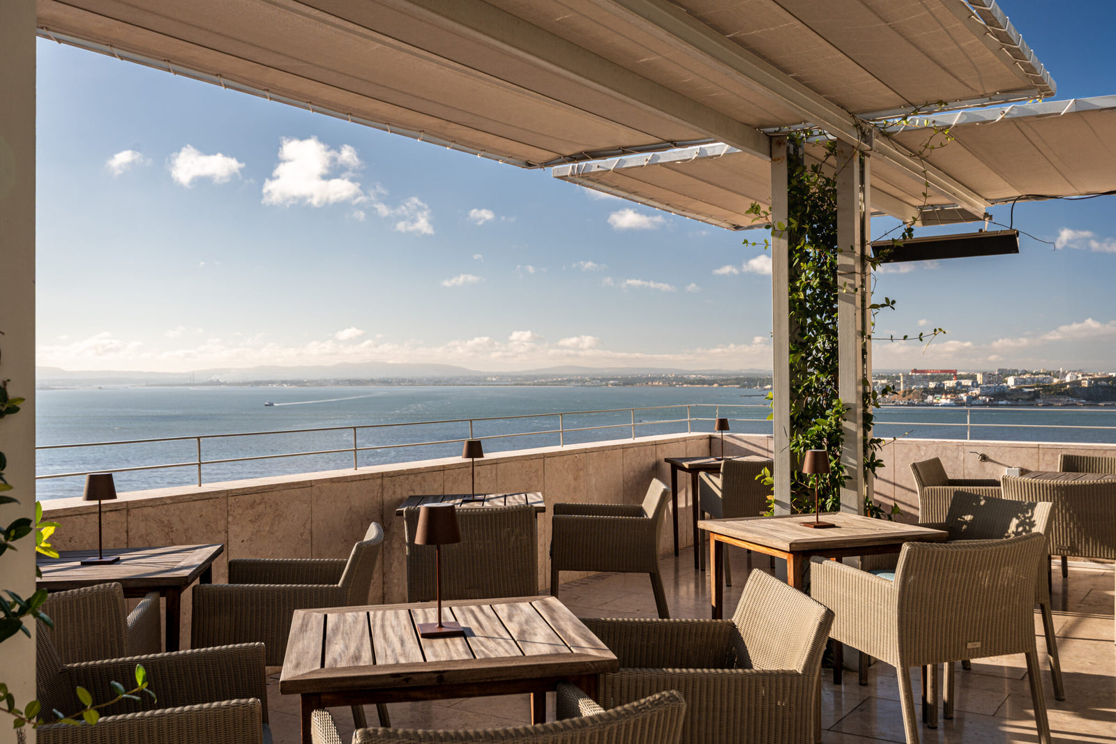 Rooftop terrace of Verride Palacio de Santa Catarina overlooking Lisbon and the Tejo river at golden hour