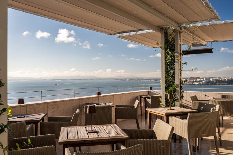 Rooftop terrace of Verride Palacio de Santa Catarina overlooking Lisbon and the Tejo river at golden hour