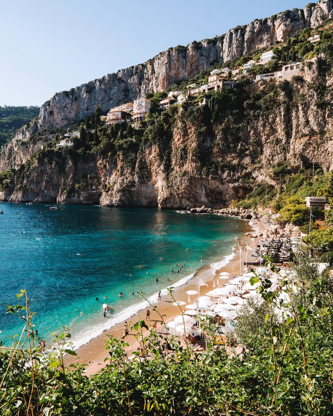 Clear blue water and sandy beach on the French Riviera coastline