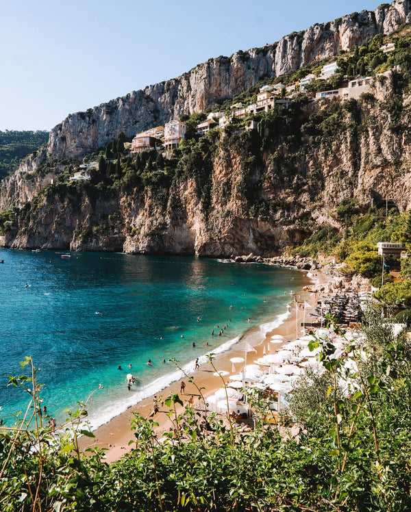 Clear blue water and sandy beach on the French Riviera coastline
