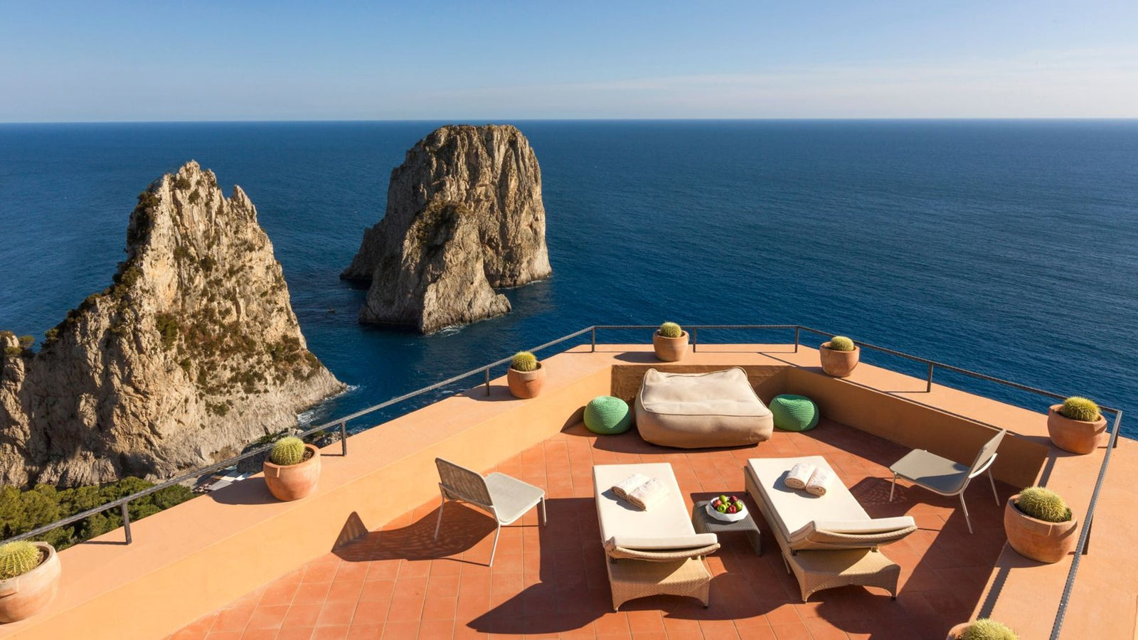 A Capri terrace above the Faraglioni, the legend of the coast