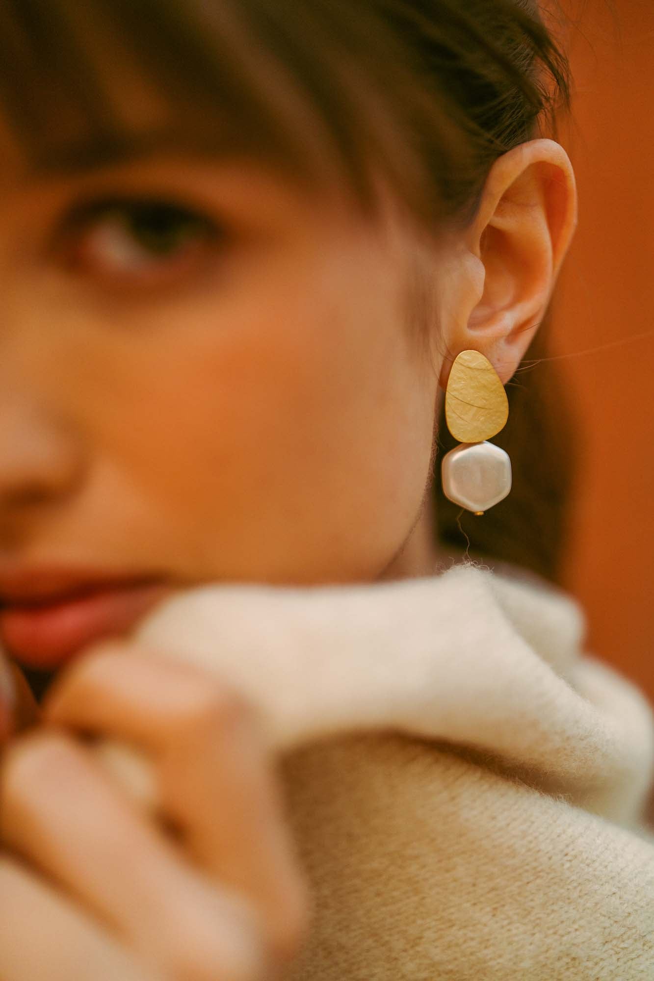 A modern pearl earring worn close to the skin, Reflections by Sofia Godinho