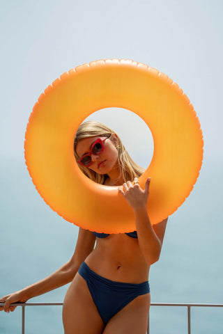 Model wearing the Azurée navy ruched bandeau bikini by Sofia Godinho