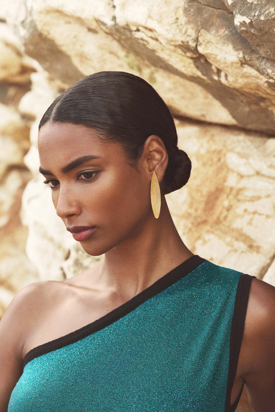 Alloro golden earrings worn with a one-shoulder look, Sofia Godinho