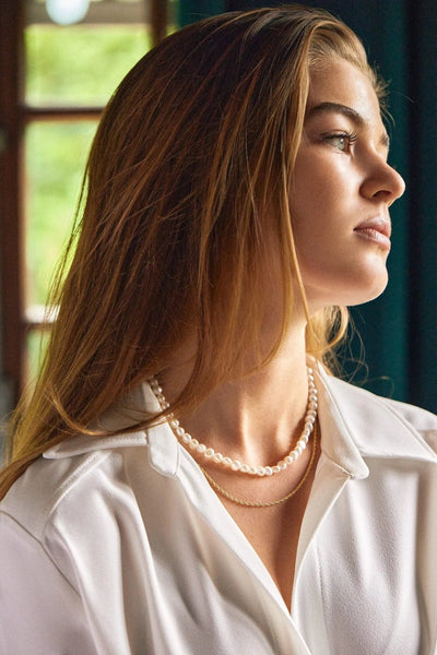 Styled flat-lay — Elizabeth Pearls Necklace layered with gold pieces