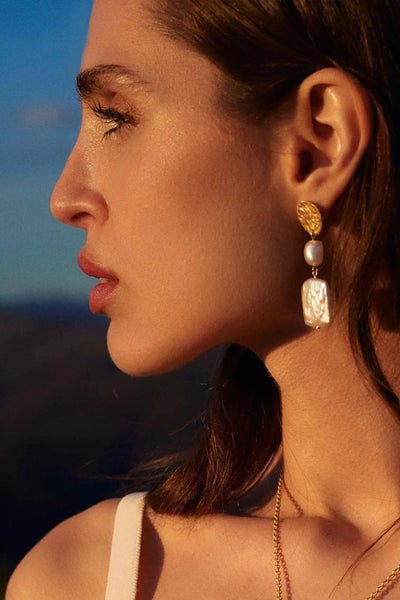 Close-up of Heraklion Pearls XL Earrings showing pearl size and golden hooks