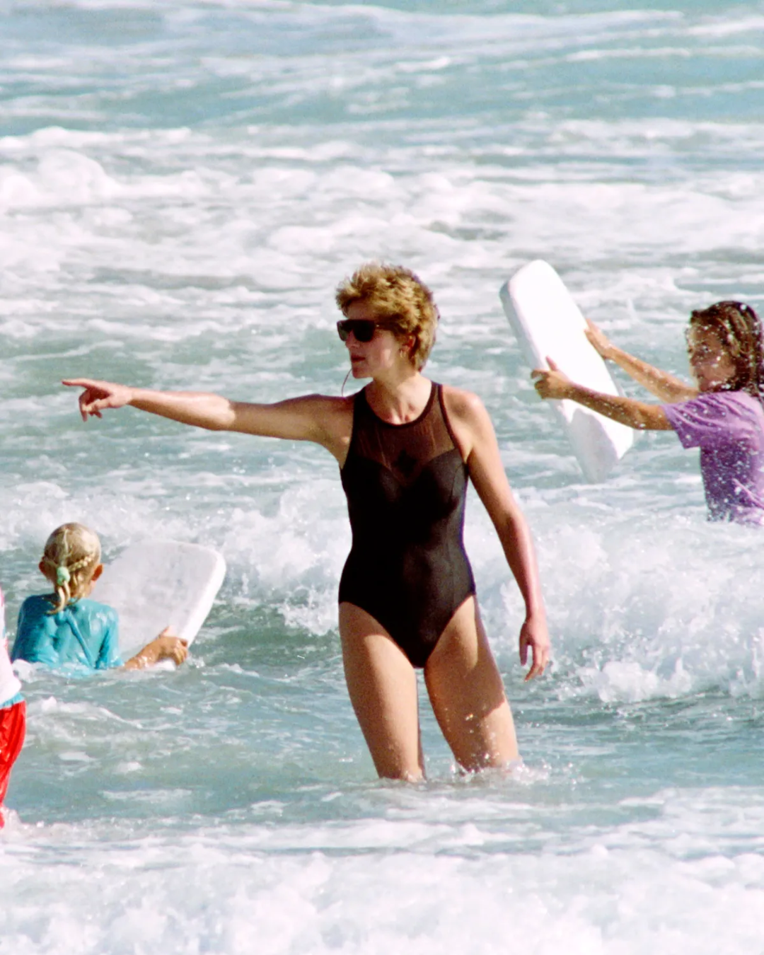 Lady Diana wearing classic black one-piece swimsuit
